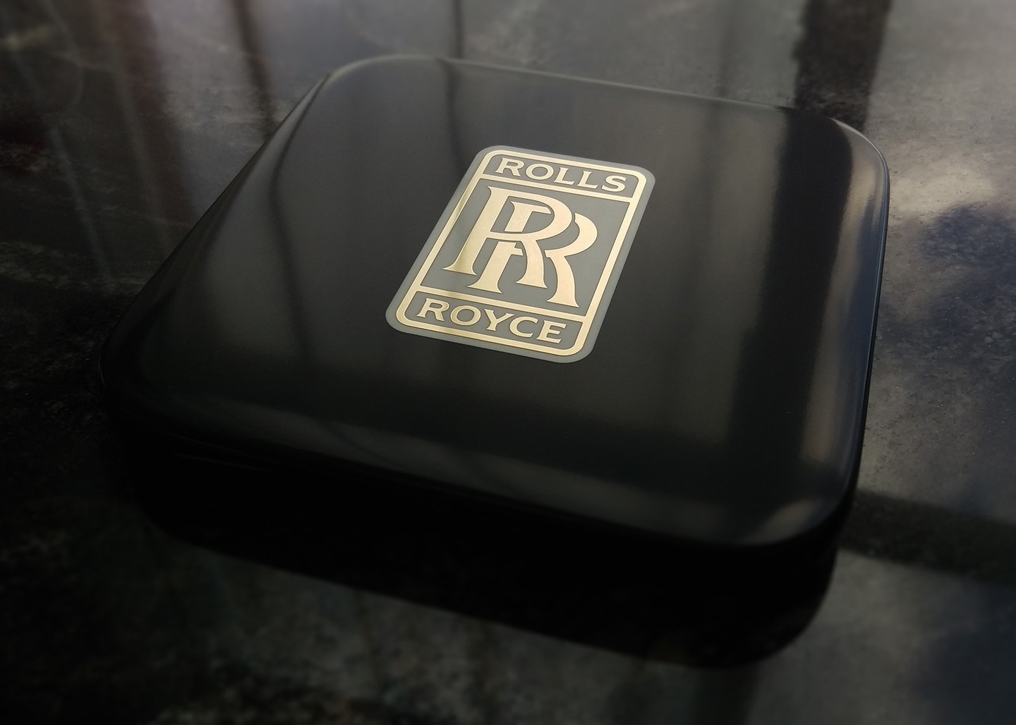 A drinks coaster in Corian, brass and resin