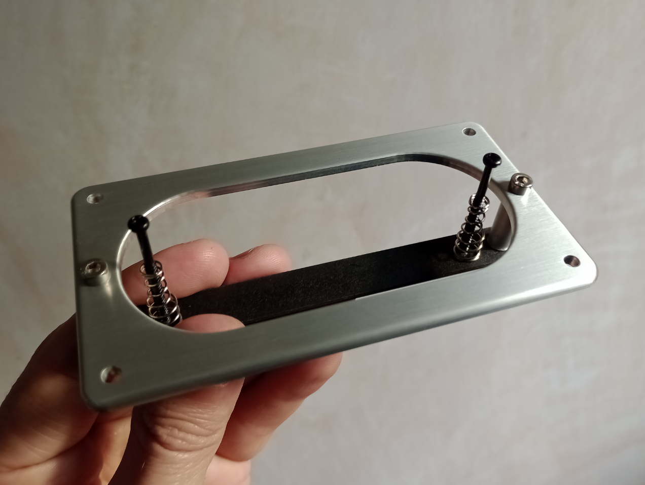 Aluminium pick-up surround for a hollow-body with under-slung pick-up mount